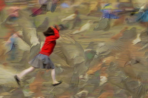Girl chasing pigeons
