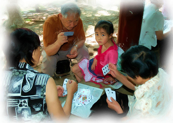 Family playing cards in Green Lake Park, Kunming